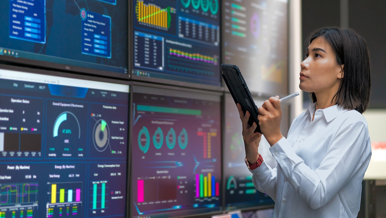 Woman looking at the stats on wide screen