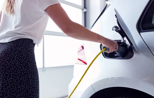 Electric car charger being plugged in to a car 