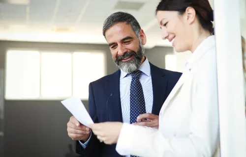 Male and female executives standing having a conversation