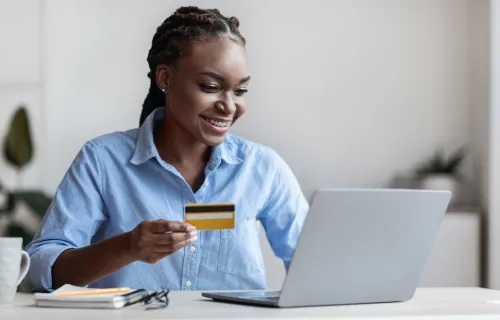 A person holding a credit card making an online payment