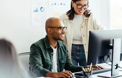 ServiceNow consultants look at computer together