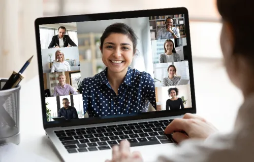 Person watching video call on laptop screen