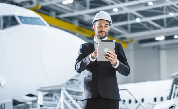 Aerospace engineer holding a tab and analysing the design