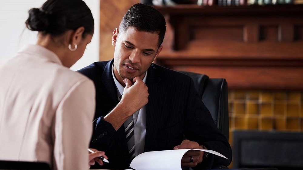 Two professionals reviewing document